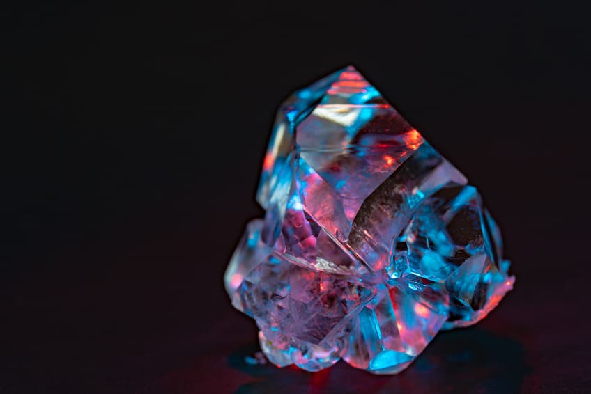 Rough diamond lighting up with multiple colors under the light | Crystal healing online